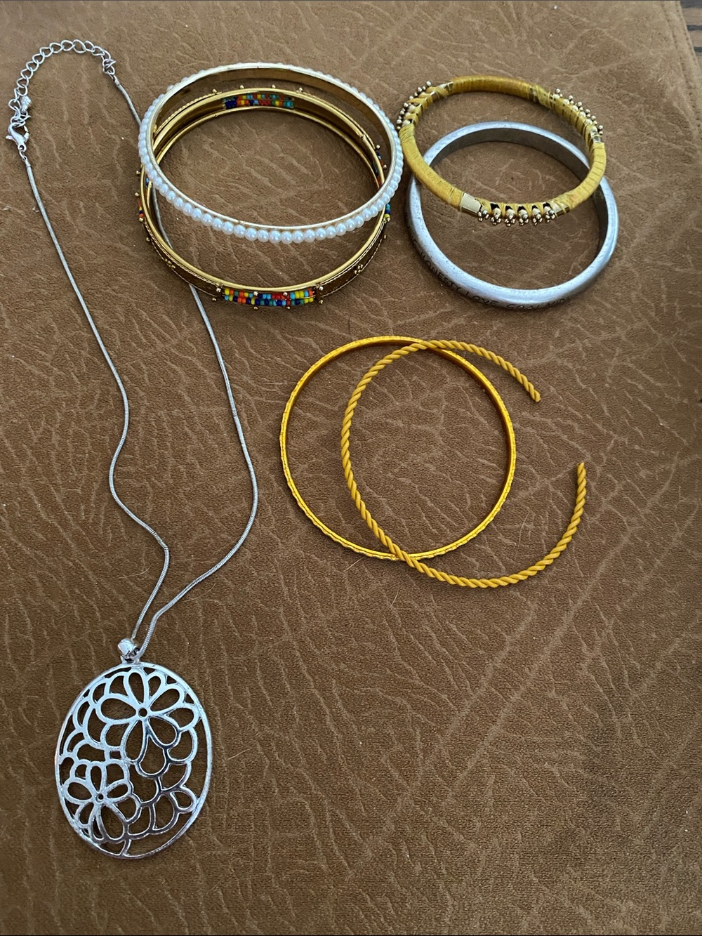 Silver Flower Pendant Necklace with a lot of bracelets